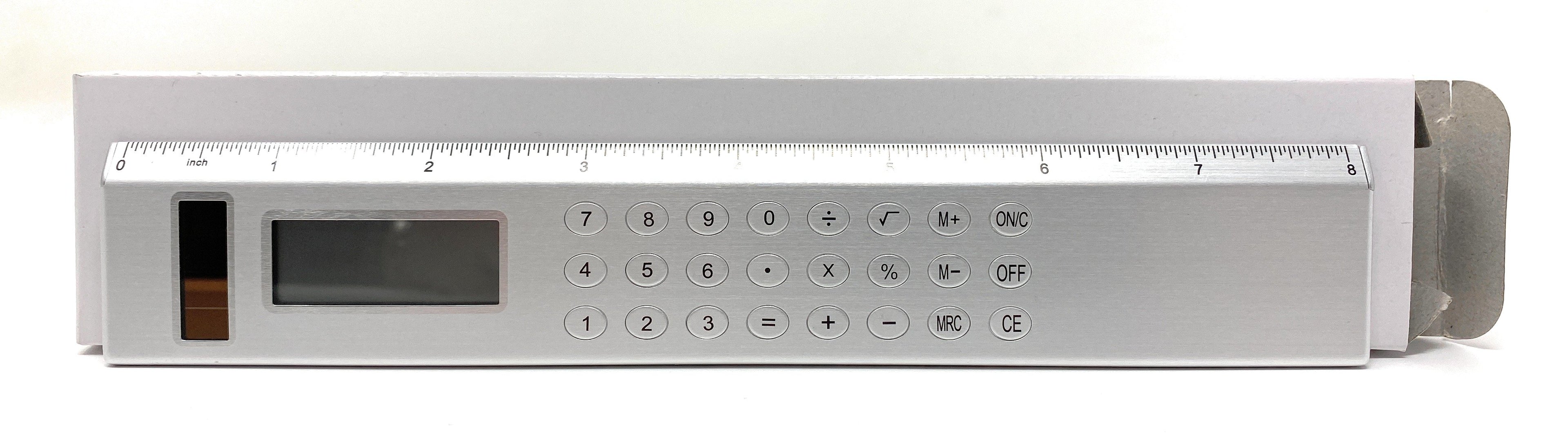 Silver Solar Powered Calculator on an  8-inch Ruler