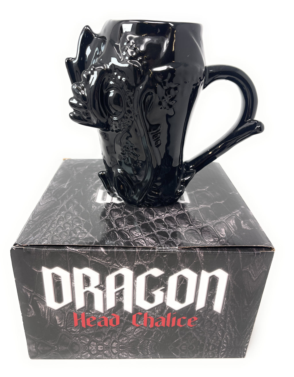 A glossy black ceramic dragon head mug displayed on top of its black retail box, which features the text 'Dragon Head Chalice' in white and red lettering.