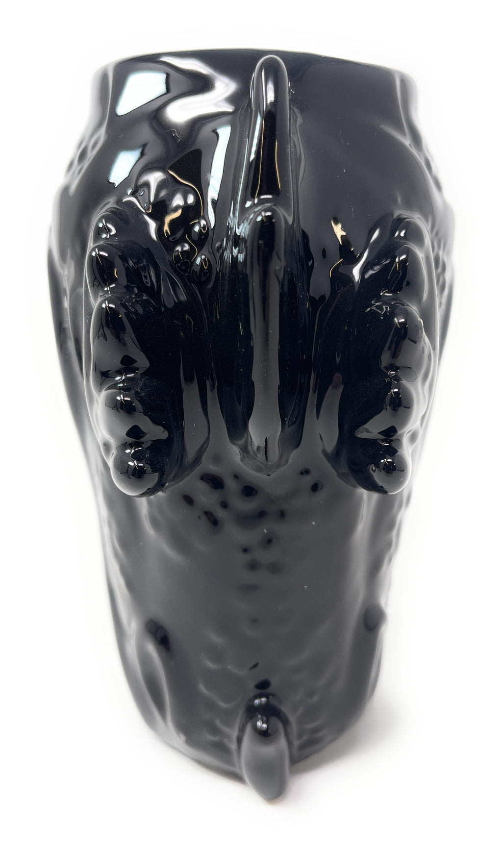A glossy black ceramic mug shaped like a stylized dragon head, shown from the front on a plain white background.