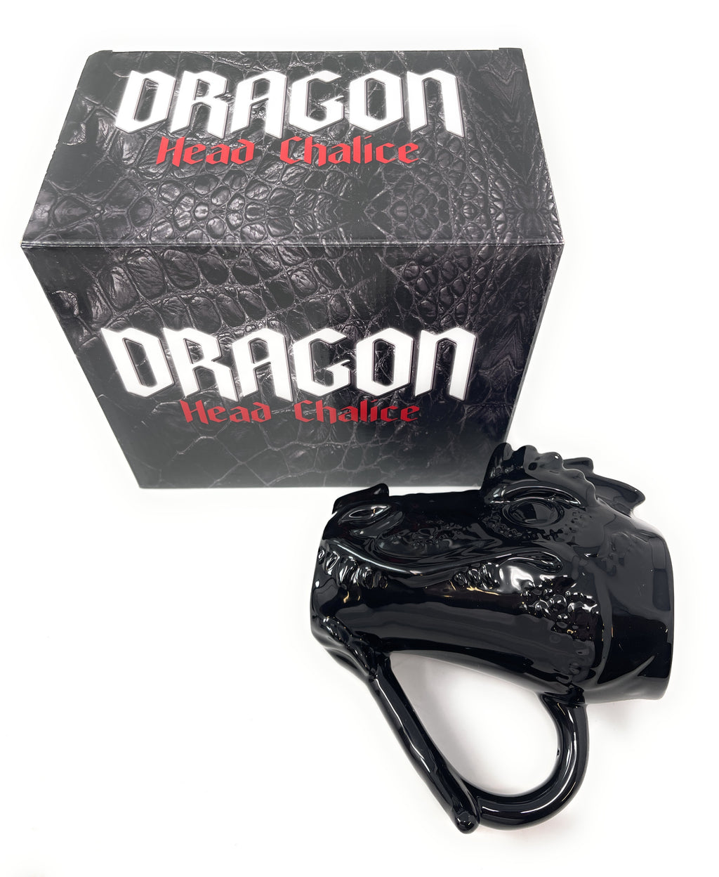 A glossy black dragon head mug positioned in front of its black textured retail box, which features the text 'DRAGON Head Chalice' in white and red, set against a plain white background.