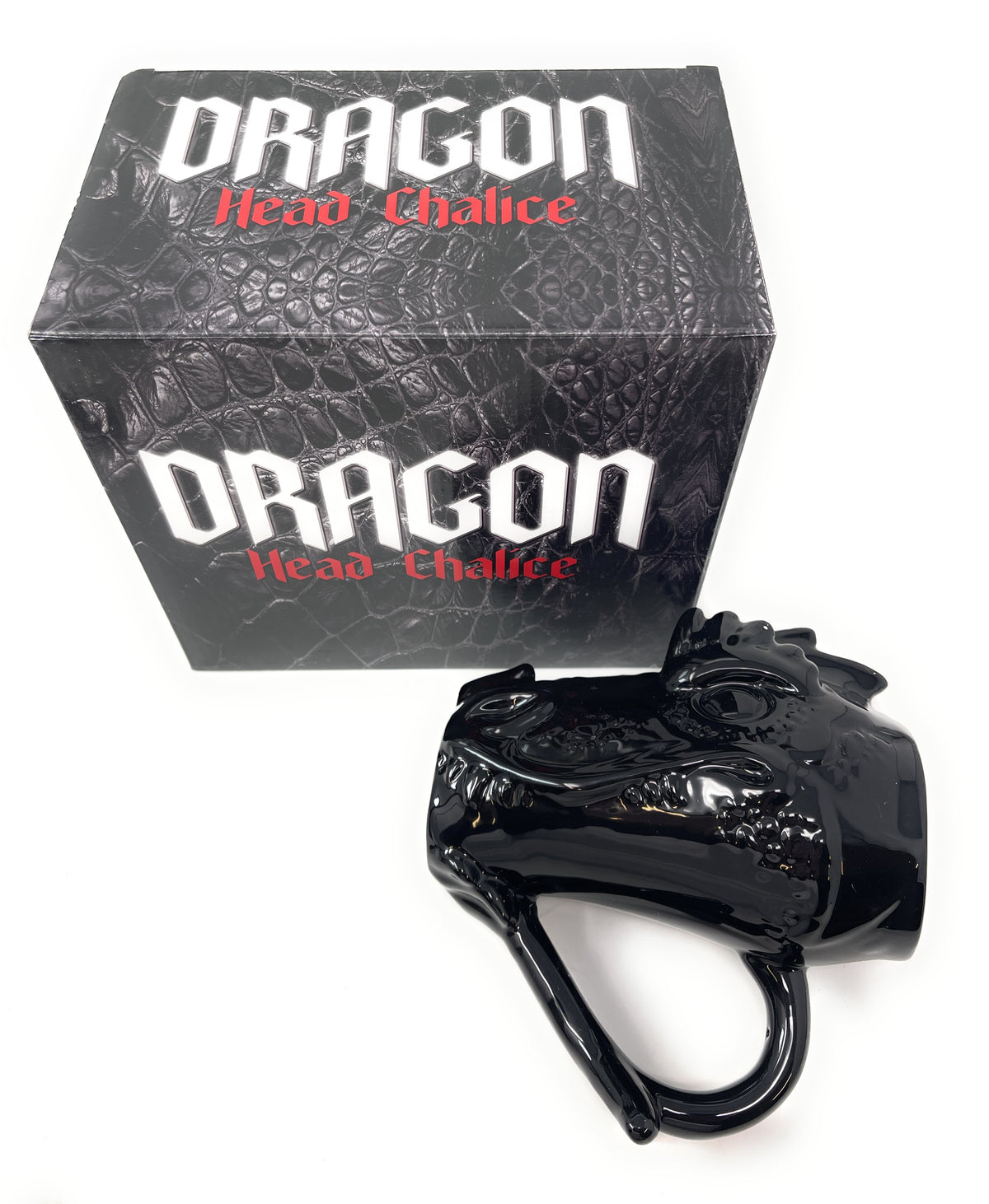 A glossy black dragon head mug positioned in front of its black textured retail box, which features the text 'DRAGON Head Chalice' in white and red, set against a plain white background.
