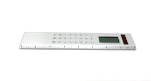 Silver Solar Powered Calculator on an  8-inch Ruler